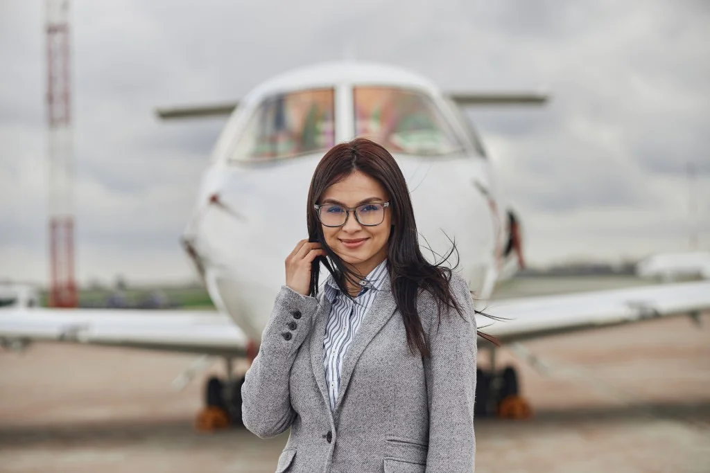 Woman stand in front of private jet