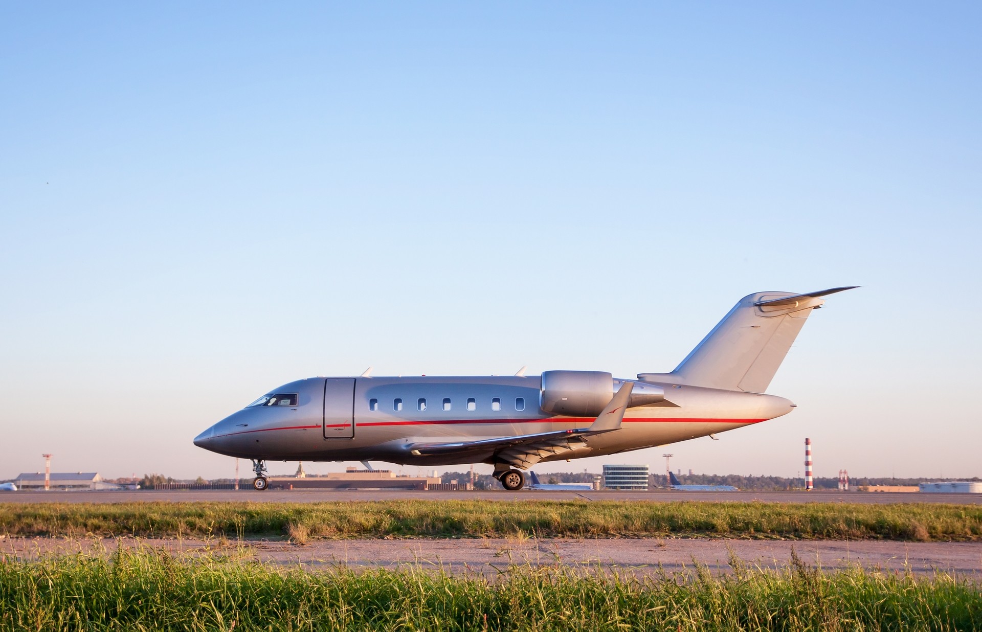 A luxorious business jet plane Canadair Chellenger 600 standing on an apron of an airport